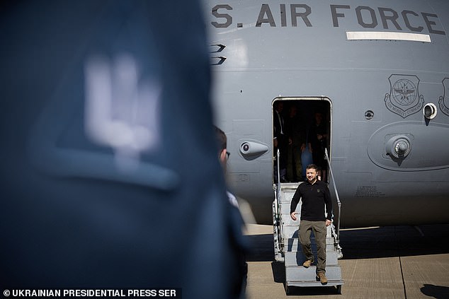 Zelensky is photographed disembarking from a US Air Force plane before heading to the munitions factory, where he poses with leading Democrats