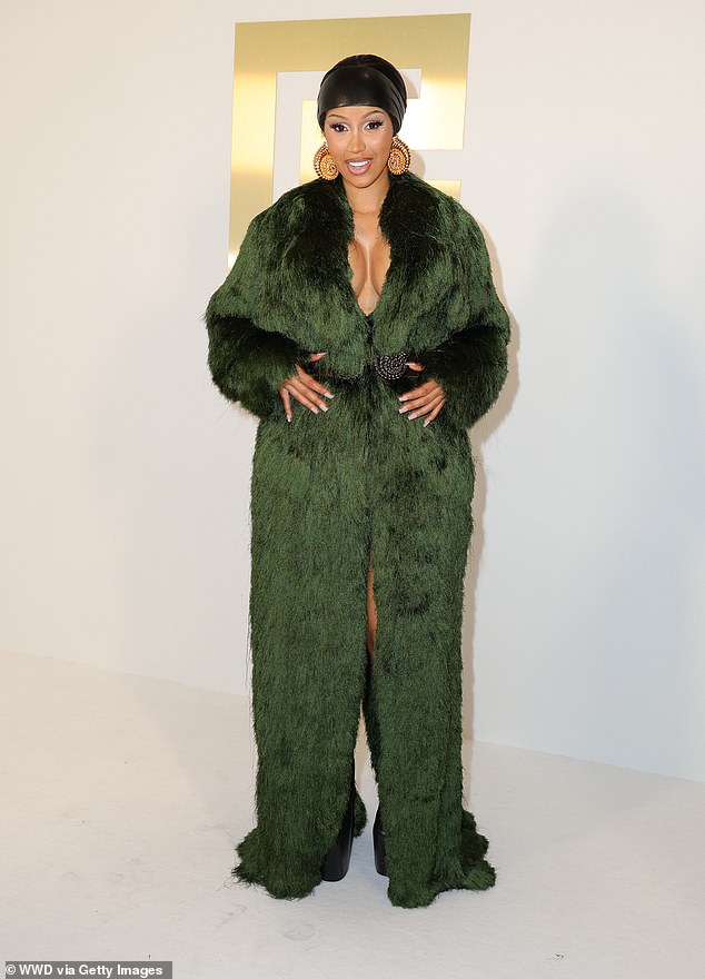 Cardi B, 31, showed off a fuller bust in a green fur dress and wore sky-high black heels and statement gold earrings as she stepped out