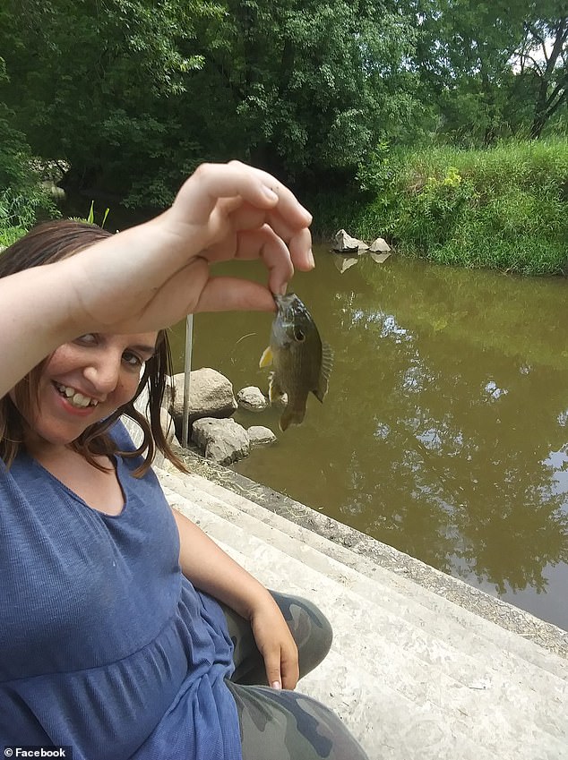 Jackson laughing after catching a fish