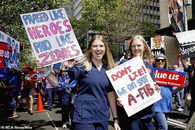 A nurse held a sign that read: 'Praised as heroes, paid like zeros' (photo)