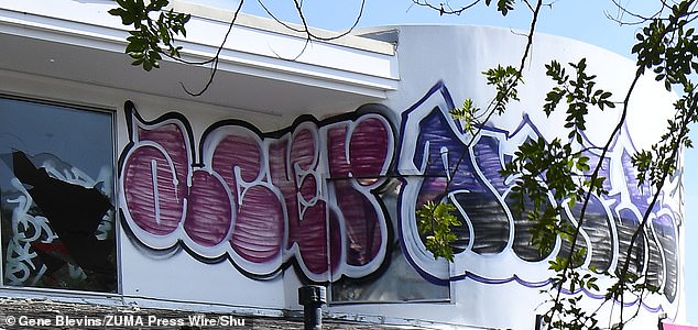 City workers were busy installing a fence Tuesday and Los Angeles Police Department officers were on the scene as some of the graffiti was removed.