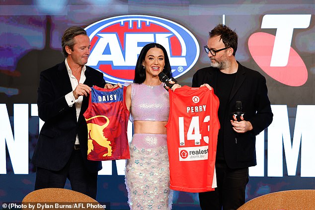 Perry tried her hand at Australian slang and AFL references in a press conference peppered with 'speccy' and 'granny' after a run on the grass in heels to practice handball with AFLW stars