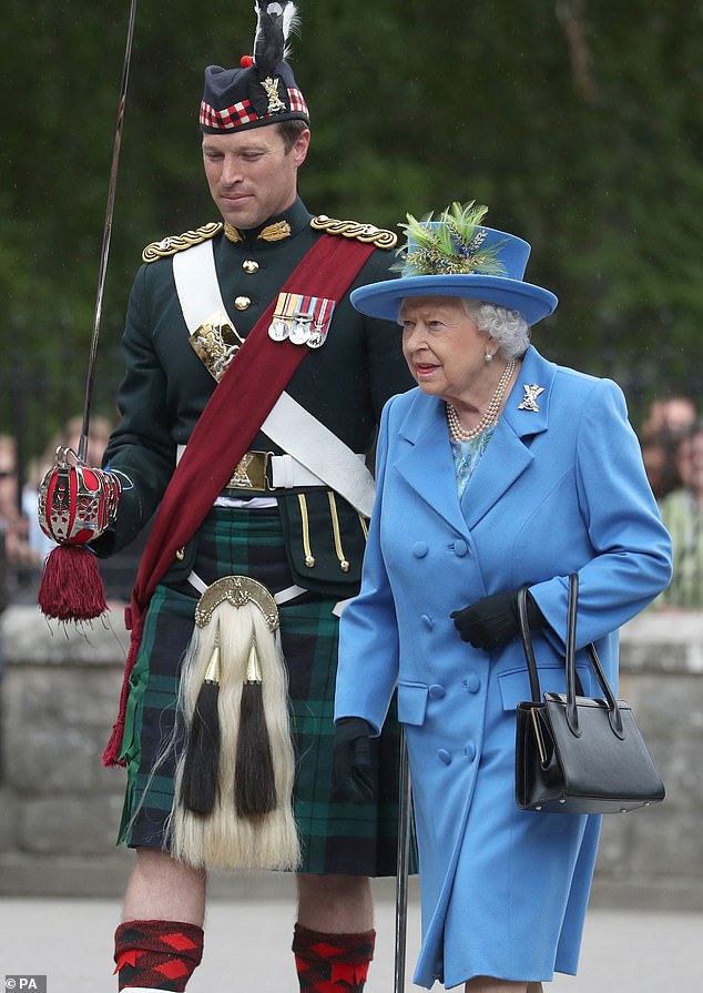 Lieutenant Colonel Jonathan 'Johnny' Thompson accompanies the late Queen Elizabeth as she inspects troops at the gates of Balmoral in 2018