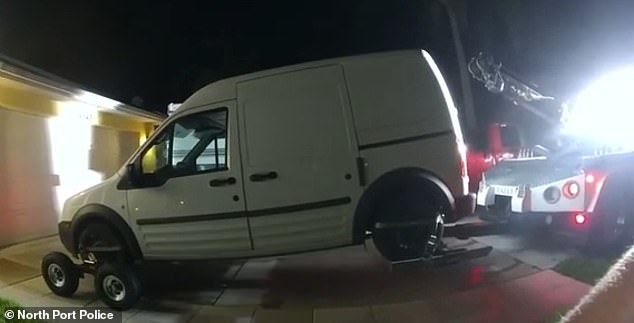 After the confrontation, the officer explains that the van is registered to Petito only and that he is arranging for a tow to retrieve the vehicle. Pictured: Petito's cross-country van being towed by North Port police