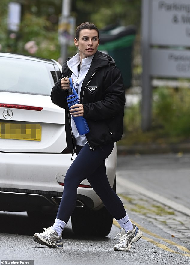 The WAG, 38, wore a gray quarter-zip with an American flag on it, under a black Prada bomber jacket during the outing