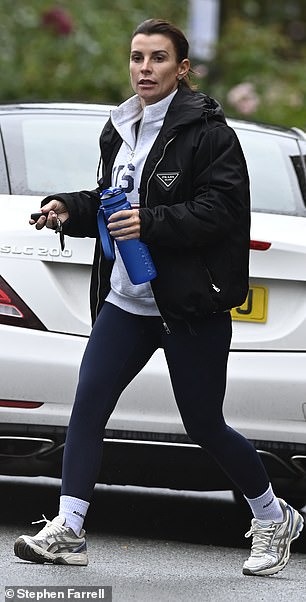 The mother of four wore her dark hair swept back with minimal makeup, while also carrying a bottle of water