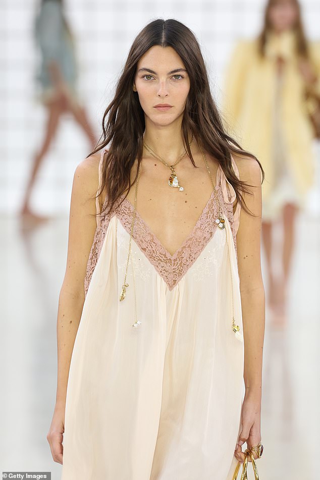 The 26-year-old model stood out in a sheer cream-colored dress with a plunging neckline that was covered in pink lace