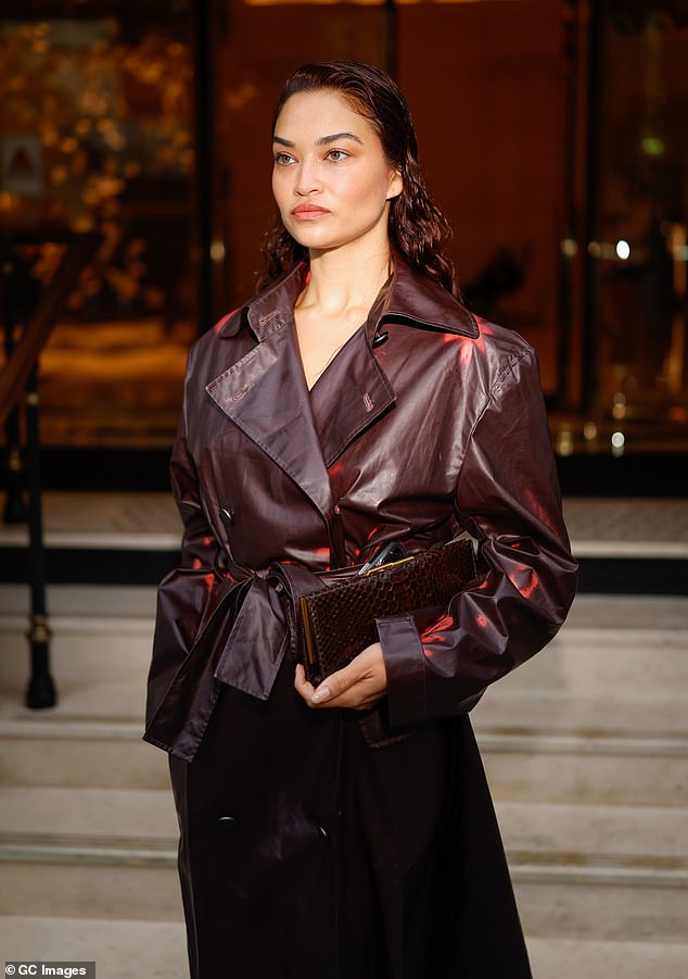 The Australian model, 33, stunned in a maroon leather trench coat as she left the Christopher Esber show