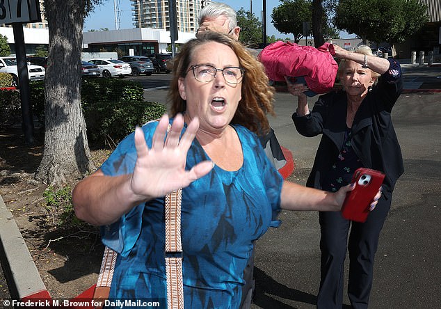 The doctor was accompanied by his daughter and wife, who tried to block the cameras