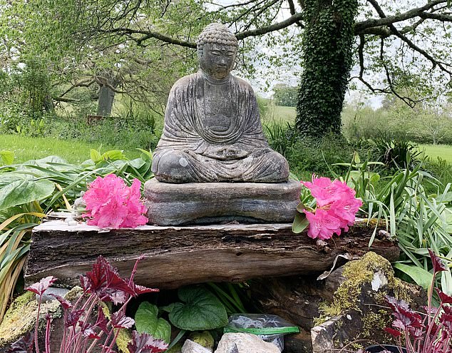 A Buddha statue in the garden of the retreat. “We are here to follow Buddha's five precepts, including non-harm,” says Caroline