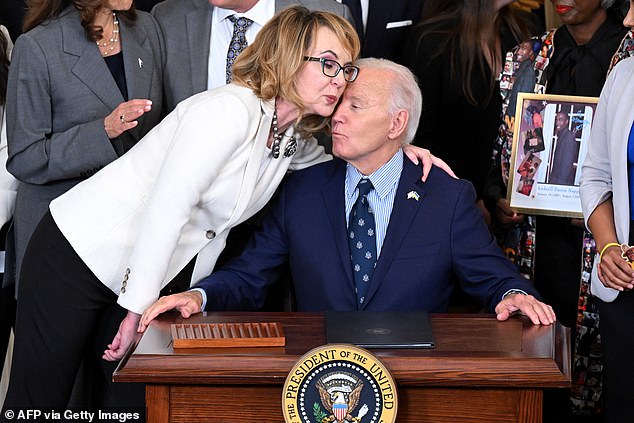 President Joe Biden (right) signs new gun control orders and hugs former Representative Gabrielle Giffords (left), who survived an assassination attempt in Tucson, Arizona in 2011