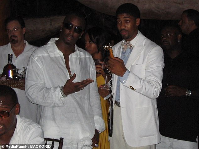 Diddy – infamous for his 'white parties' – wore an all-white outfit and was seen grabbing a strawberry and eating it as he stood next to the naked woman