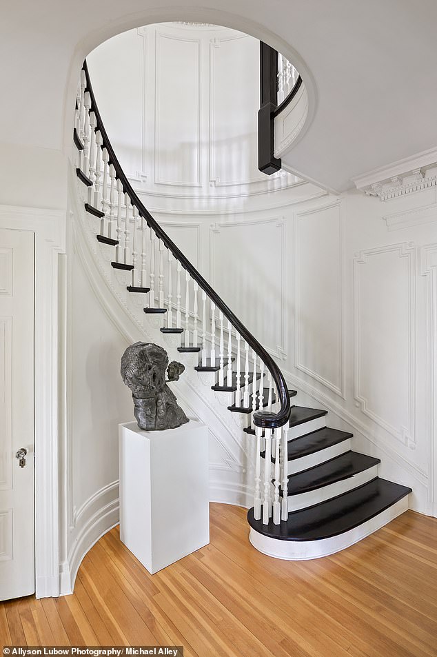 Original architectural details include a grand staircase, formal living room and library with floor-to-ceiling bookshelves