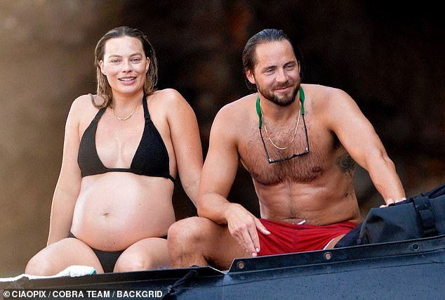 Barbie actress Margot is currently awaiting the arrival of her first child with husband Tom Ackerley, 34 (both pictured in August)