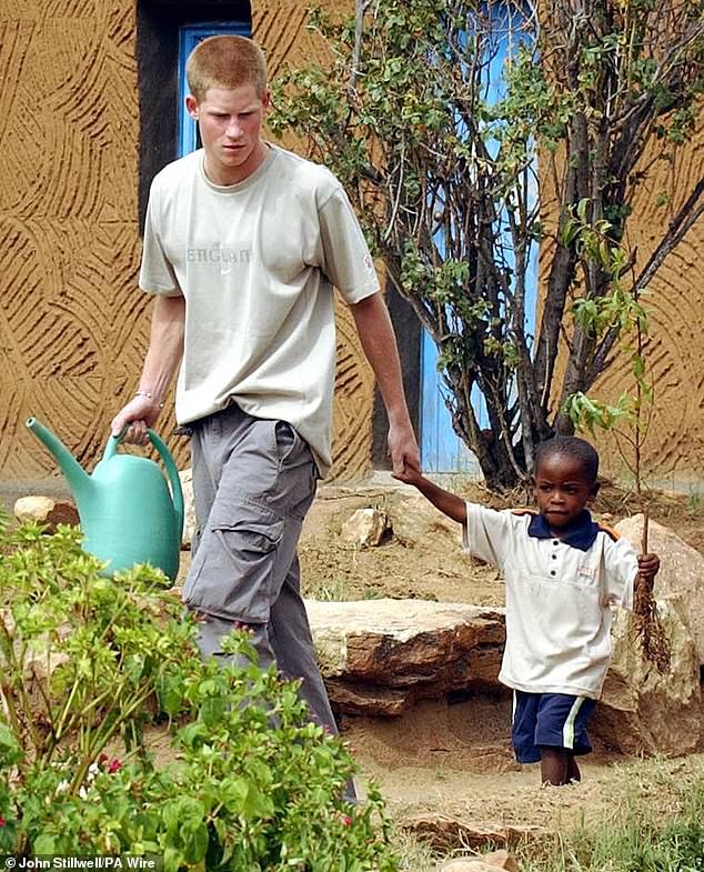 Harry is pictured on his first visit to Lesotho as a 19-year-old, in March 2004