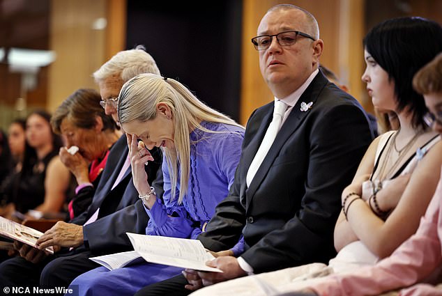 Charlotte O'Brien's mother is pictured crying next to her partner at the funeral on Friday