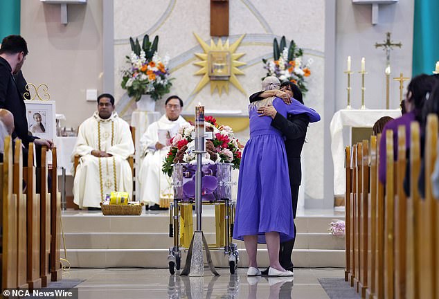 Charlotte's mother, Kelly, is photographed at her daughter's funeral on Friday