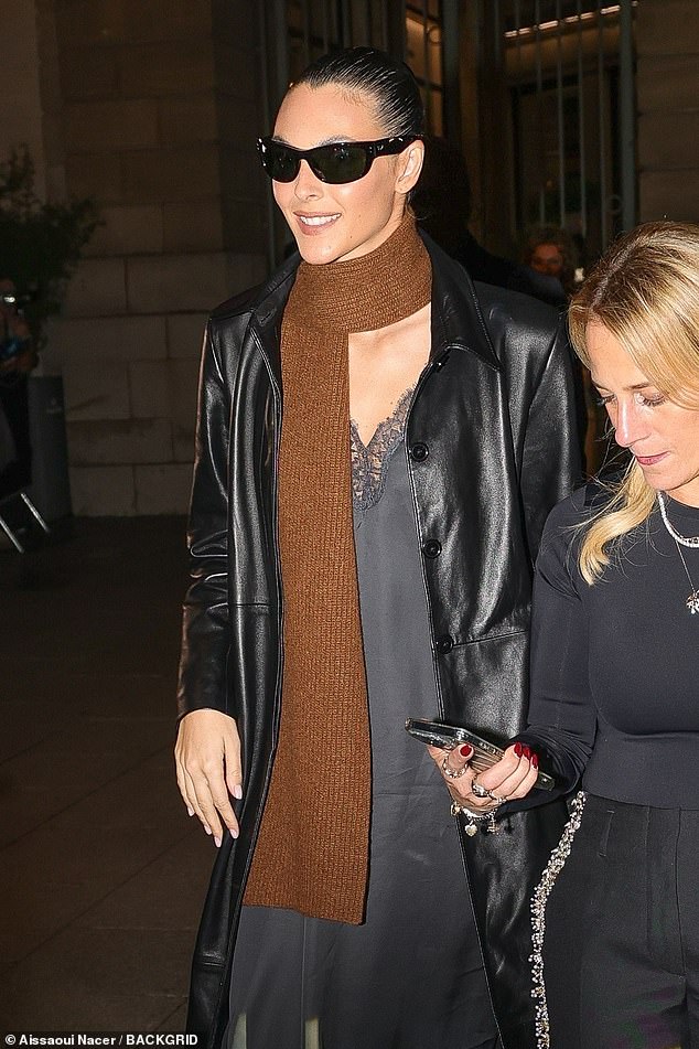 Vittoria wore a long leather trench coat over a chic black slip dress