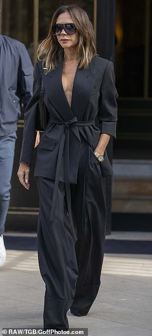 Victoria's chic blazer hugged her tiny waist and was paired with extremely wide-leg trousers