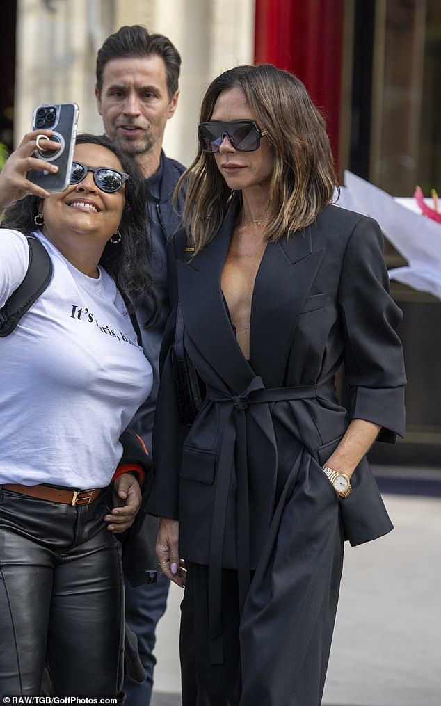 The fashion designer had her photo taken by cheeky fans before hopping into the back of her chauffeured car and leaving to get ready for the show