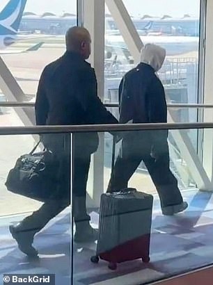 In a rare appearance, he walked through the airport alone without his wife Bianca