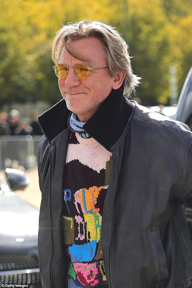 The actor, 56, opted for a striking colorful sweater which he wore under a charcoal gray motorcycle jacket