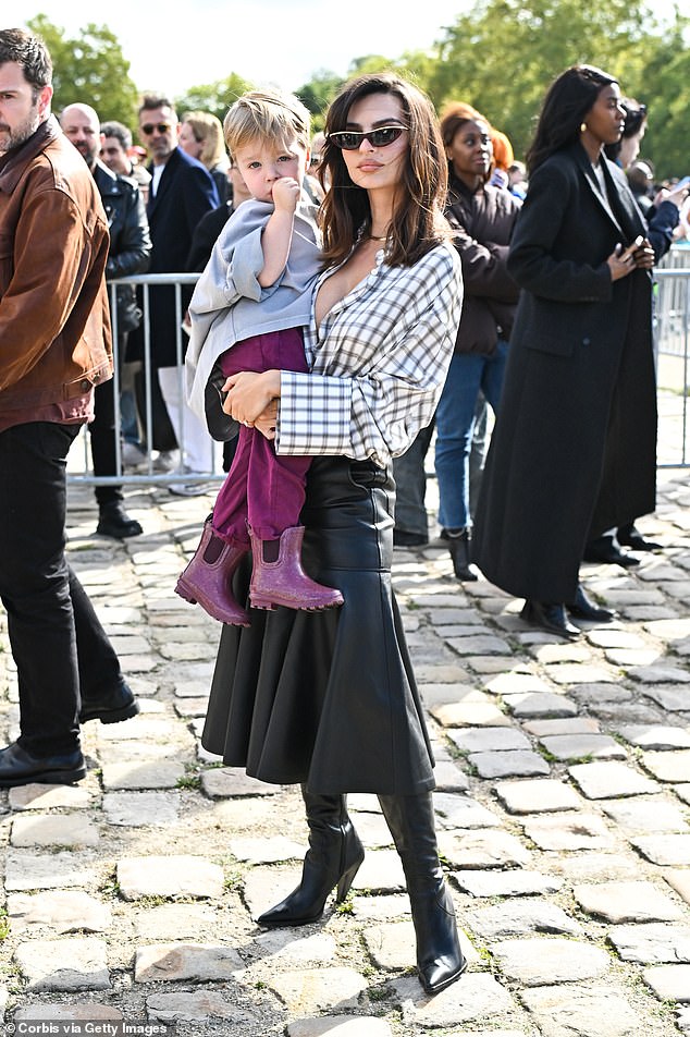 Emily Ratajkowski brought her son to the show while holding Sylvester Apollo Bear, three, in her arms