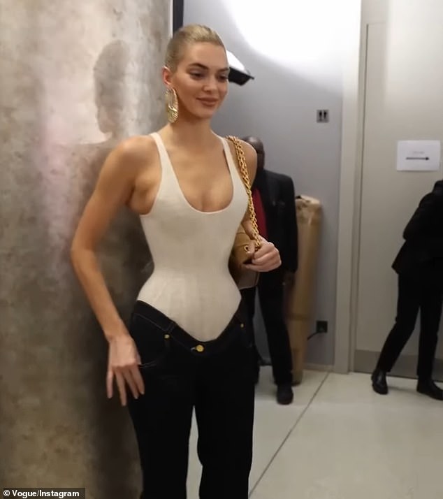 A video uploaded to Instagram by Vogue showed Jenner hanging out backstage in an extremely tight corset bodysuit