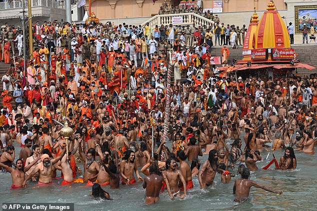 Hindu holy men take a holy dip in the waters of the Ganges during a religious ceremony in 2021