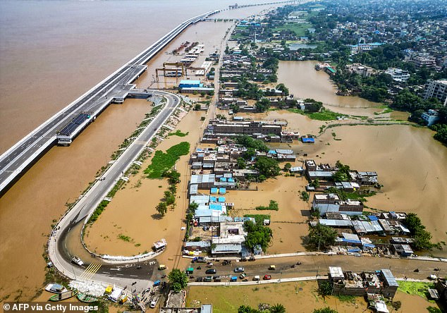 Houses partially submerged in floodwaters of the Ganges River, in Patna on September 20