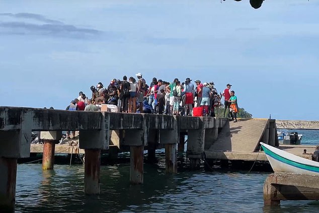 They are met on the dock (above) by foot soldiers from the Gaitanist Self-Defense Forces of Colombia, a powerful paramilitary drug cartel that controls the region's smuggling routes.