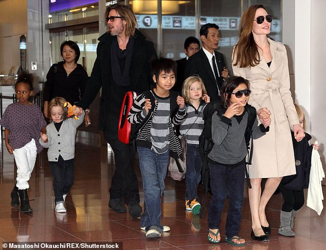 Jolie and Pitt are pictured with all their children at Tokyo airport in 2011, five years before the divorce that led to a rancorous custody battle