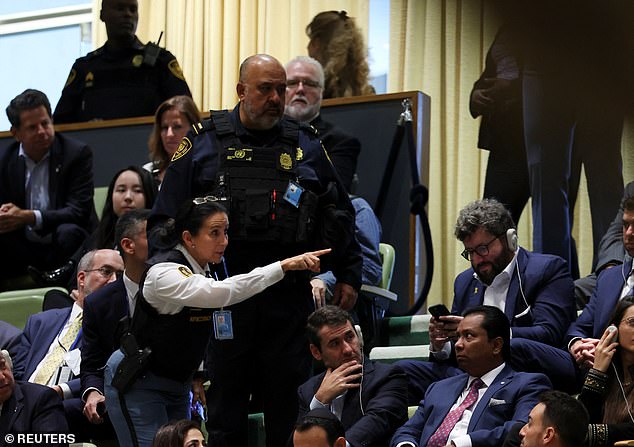 Security personnel talk to attendees as Israeli Prime Minister Benjamin Netanyahu addresses the United Nations