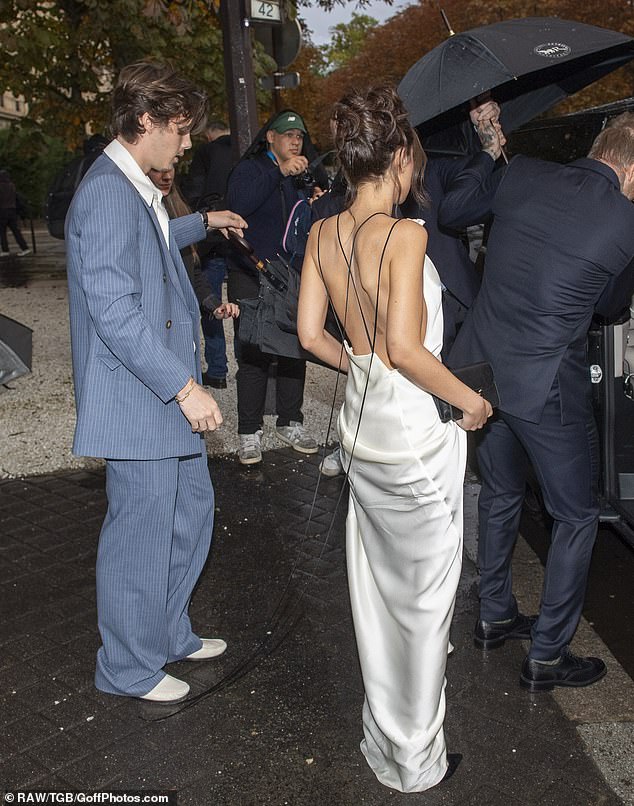 As she waited to get into the car, she showed off the beautiful back of the dress