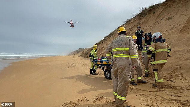 The man was found lying on the shoreline being soaked by the waves when paramedics arrived on the scene just after 8am (pictured a helicopter arriving on scene)