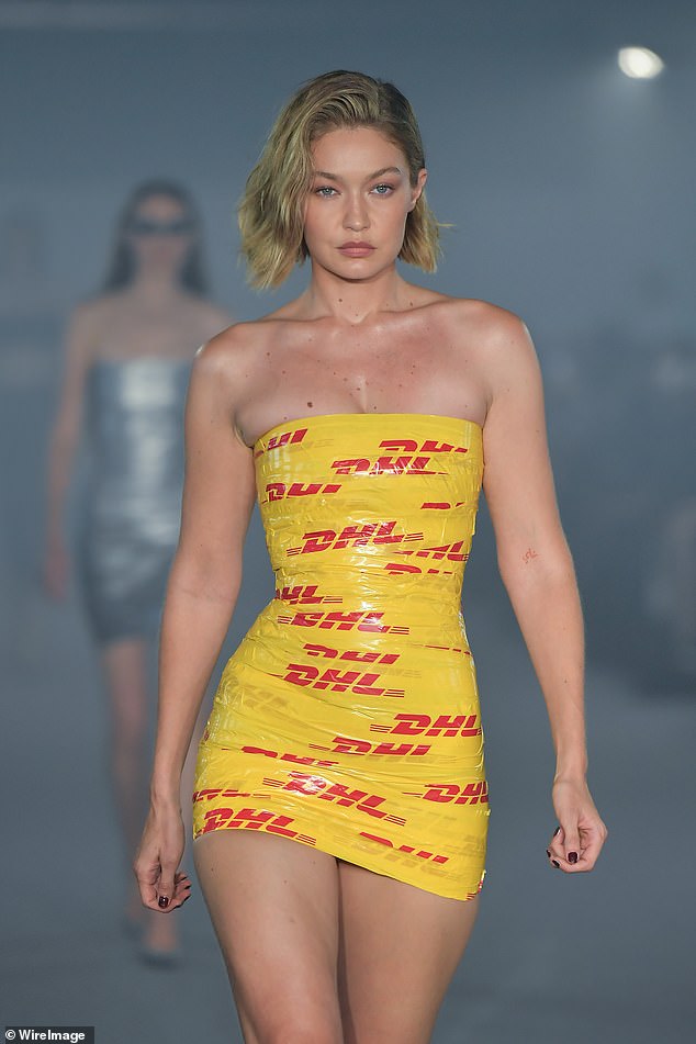 The model put on a very leggy show as she walked the catwalk in a short form-fitting dress, giving the illusion that she was wrapped in yellow and red packing tape