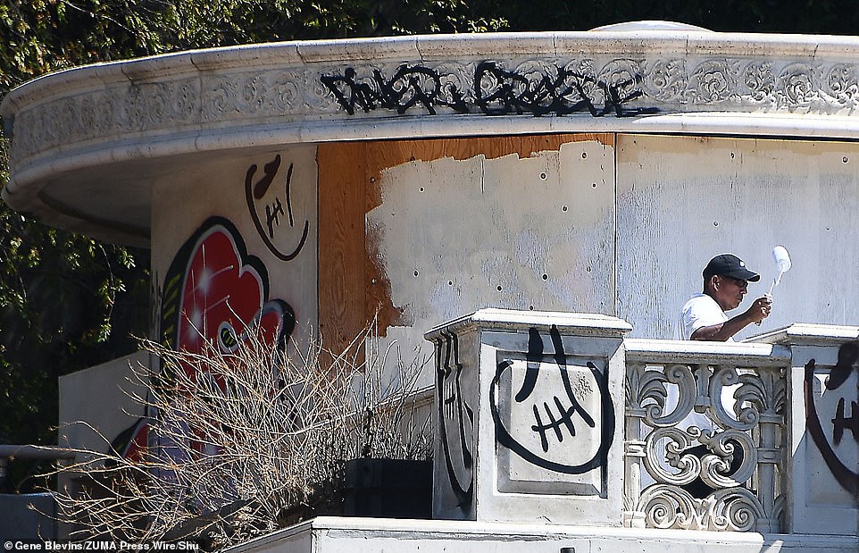 The second house received fresh paint, but days later was vandalized again with new graffiti