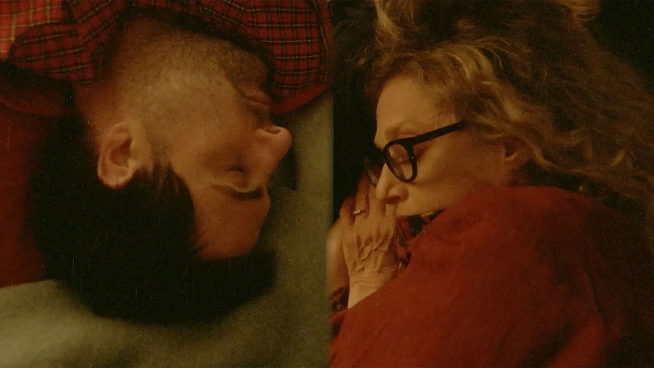 A split-screen shot of Jason Schwartzman and Carol Kane sleeping in Between the Temples.