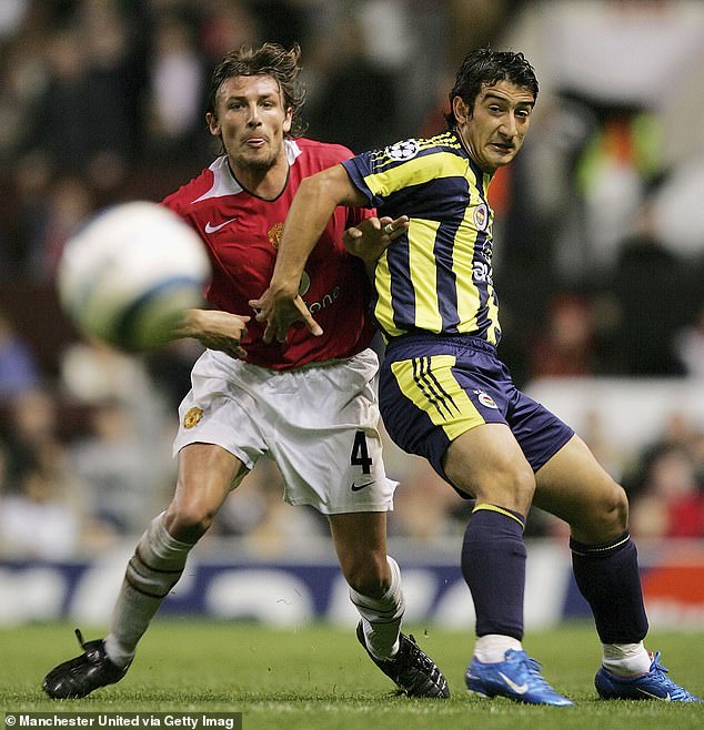 Akin (right) played for Fenerbahce and is seen playing against Manchester United's Gabriel Heinze in 2004