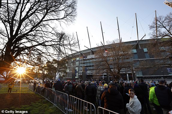 MELBOURNE, AUSTRALIA - SEPTEMBER 28: Football fans queue outside the members gates for the AFL Grand Final match between Sydney Swans and Brisbane Lions at Melbourne Cricket Ground, on September 28, 2024, in Melbourne, Australia. (Photo by Darrian Traynor/AFL Photos/Getty Images)