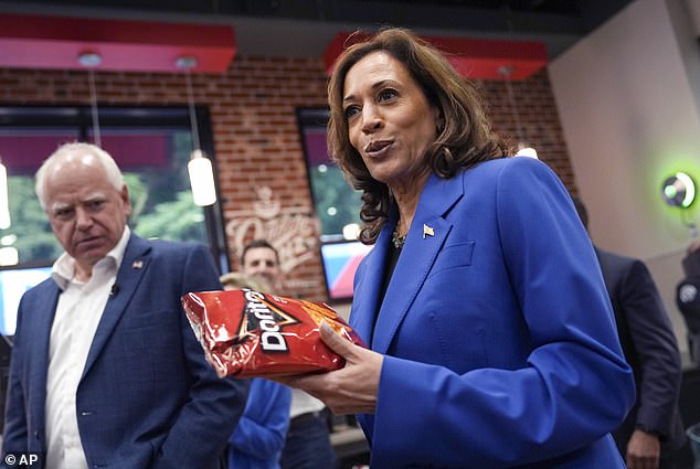 Democratic presidential candidate Vice President Kamala Harris holds a bag of Doritos chips as Democratic vice presidential candidate Minnesota Governor Tim Walz looks on at the Sheetz supermarket during a campaign stop on August 18, 2024 in Coralpolis, Pennsylvania. Only 38 percent of respondents thought Harris would be best for business