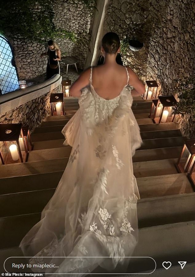 Photos showed the dress Mia wore to her wedding, which features a plunging neckline and floral embroidery along the bust and chiffon skirts, and looks nothing like the dress she originally teased in June