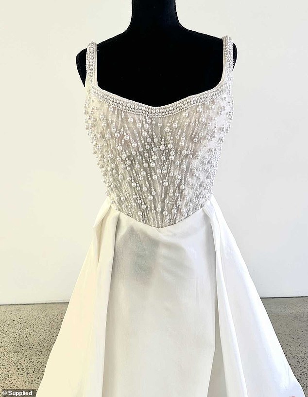 Photos of the dress designed by Champery Couture (pictured) show it features an extravagant pearl and beaded bodice and a floating tiered skirt