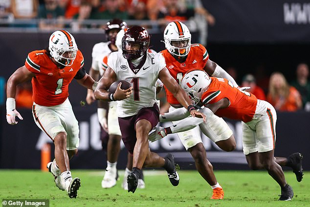 Kyron Drones #1 of the Virginia Tech Hokies carries the ball against the Miami Hurricanes