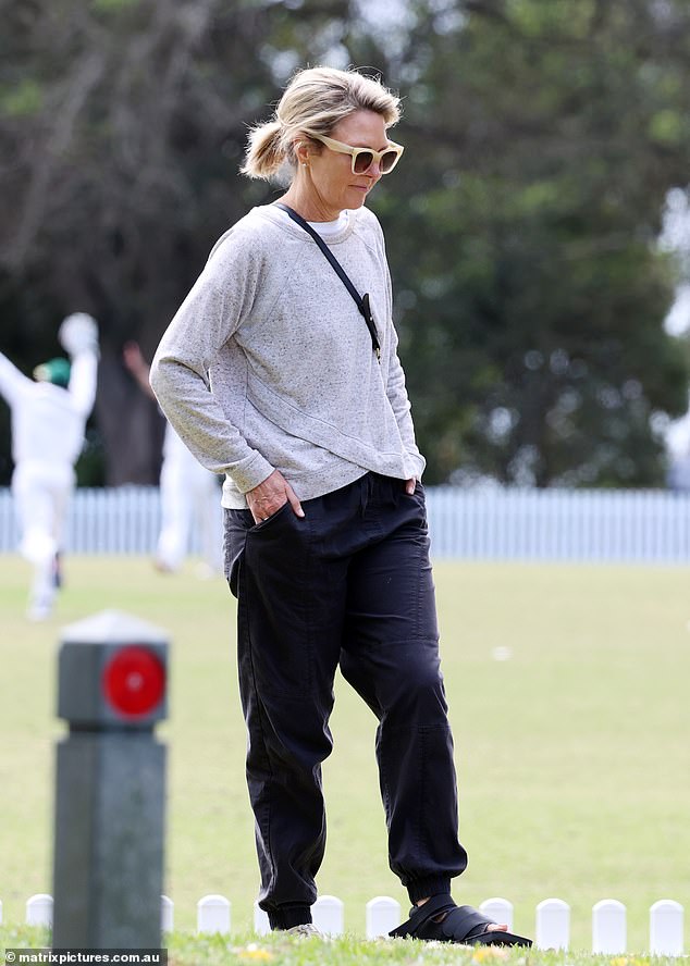 She wore orange Vieux sunglasses and a black handbag slung over her shoulder