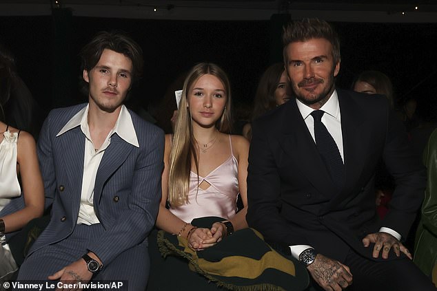 Young Harper sat between brother Cruz and father David during the show