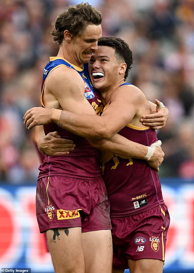 Lions teammates Joe Daniher and Cam Rayner celebrate a goal late in the fourth quarter and victory is assured at the MCG