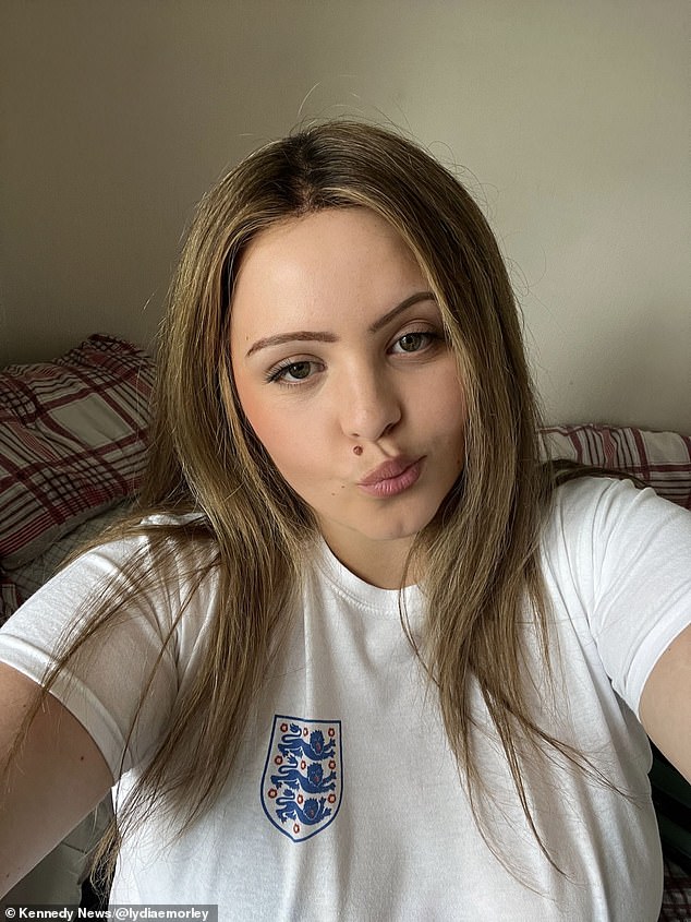 Lydia wears a brown wig and an England shirt after her diagnosis