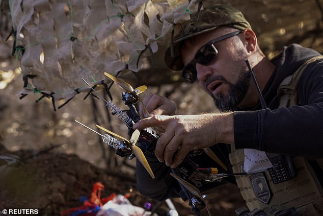 A Ukrainian soldier prepares a first person view (FPV) drone to attack Russian troops on a position near a front line on September 25, 2024