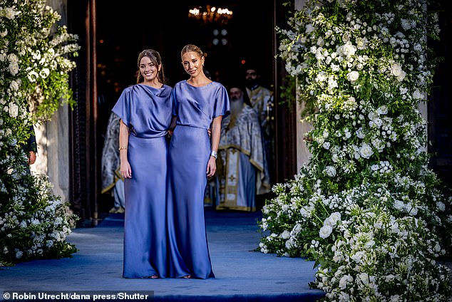 The royal family posed for photos as they stood under an impressive arch of white flowers